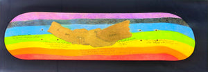 An image of a skateboard deck, featuring a colorful design with two hands clasped together labeled "Father" and "Son." The background transitions through a rainbow of colors. Inspirational quotes include "Iron sharpens iron," "Be the change you wish to see," and "A journey of a thousand miles begins with a single step."